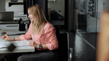 Australian architect reviewing drawings and documentation in a design studio, representing the evolving demands on architects in 2026