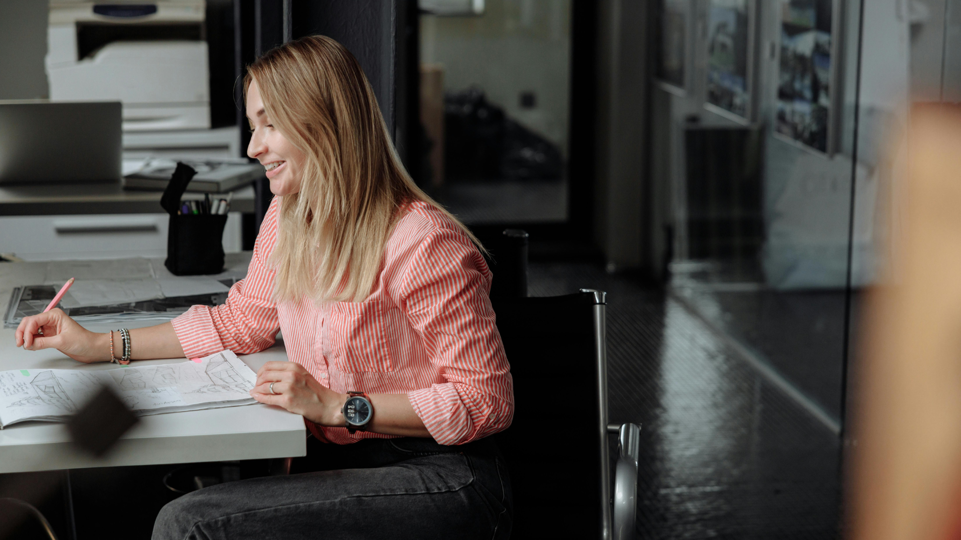 Australian architect reviewing drawings and documentation in a design studio, representing the evolving demands on architects in 2026